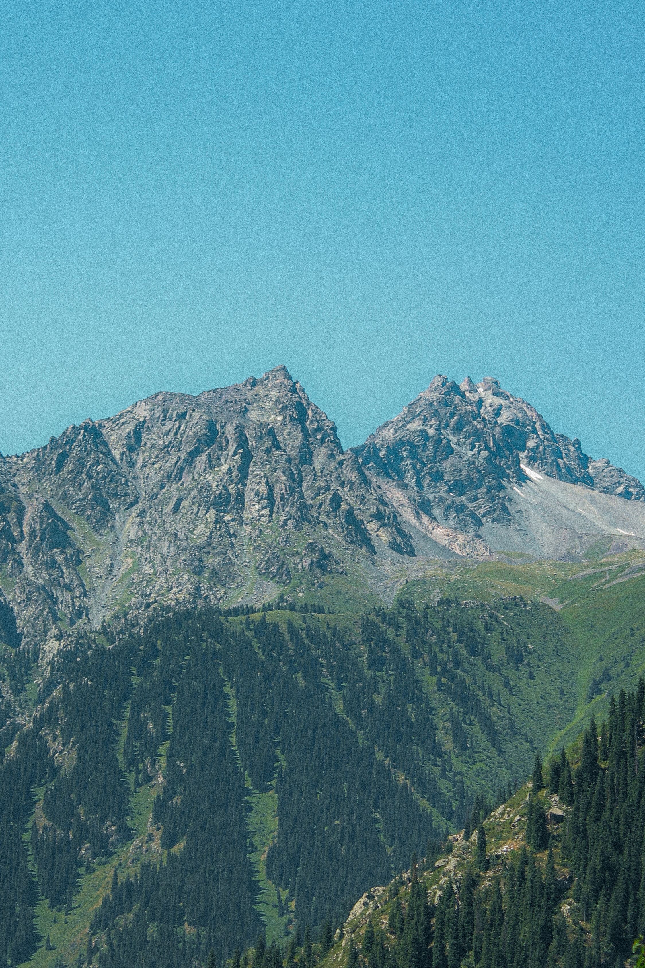 Majestic Mountain Peaks Under Clear Blue Sky · Free Stock Photo