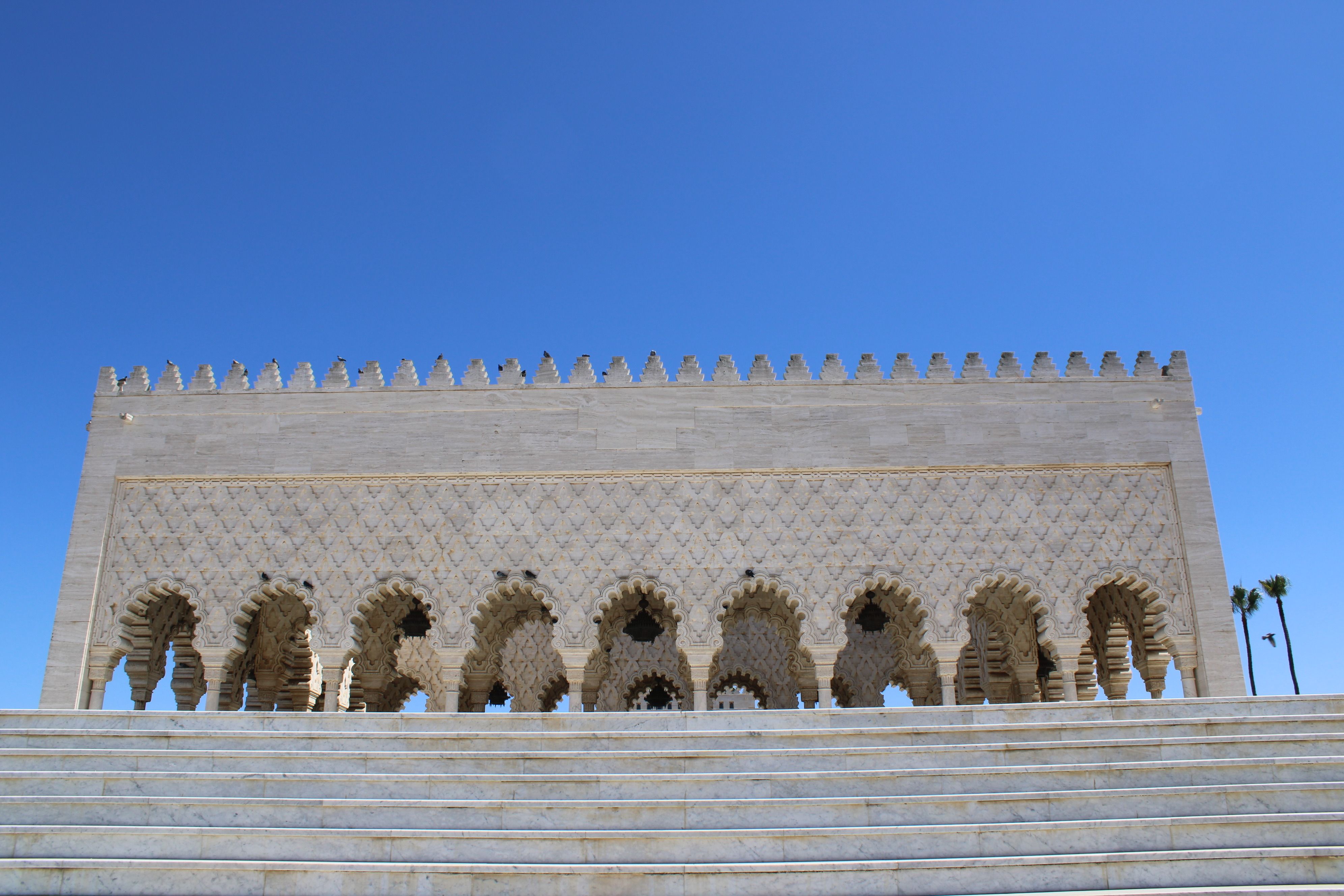 The iconic Hassan Tower, a beautiful historical minaret, in Rabat, Morocco on a clear sunny day.