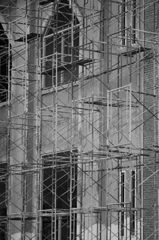Monochrome image of scaffolding on an urban building facade.