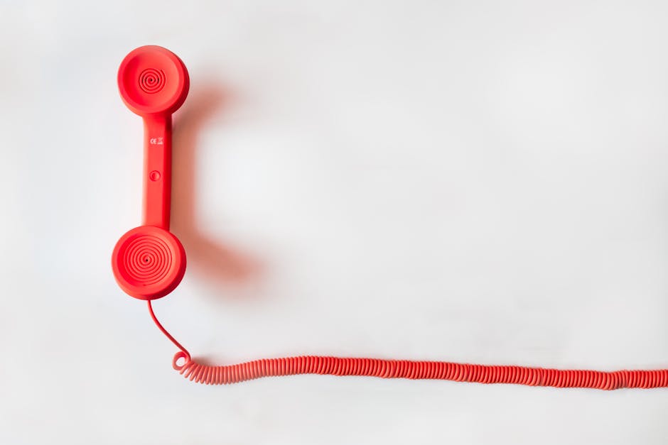 Red Corded Telephone on White Suraface