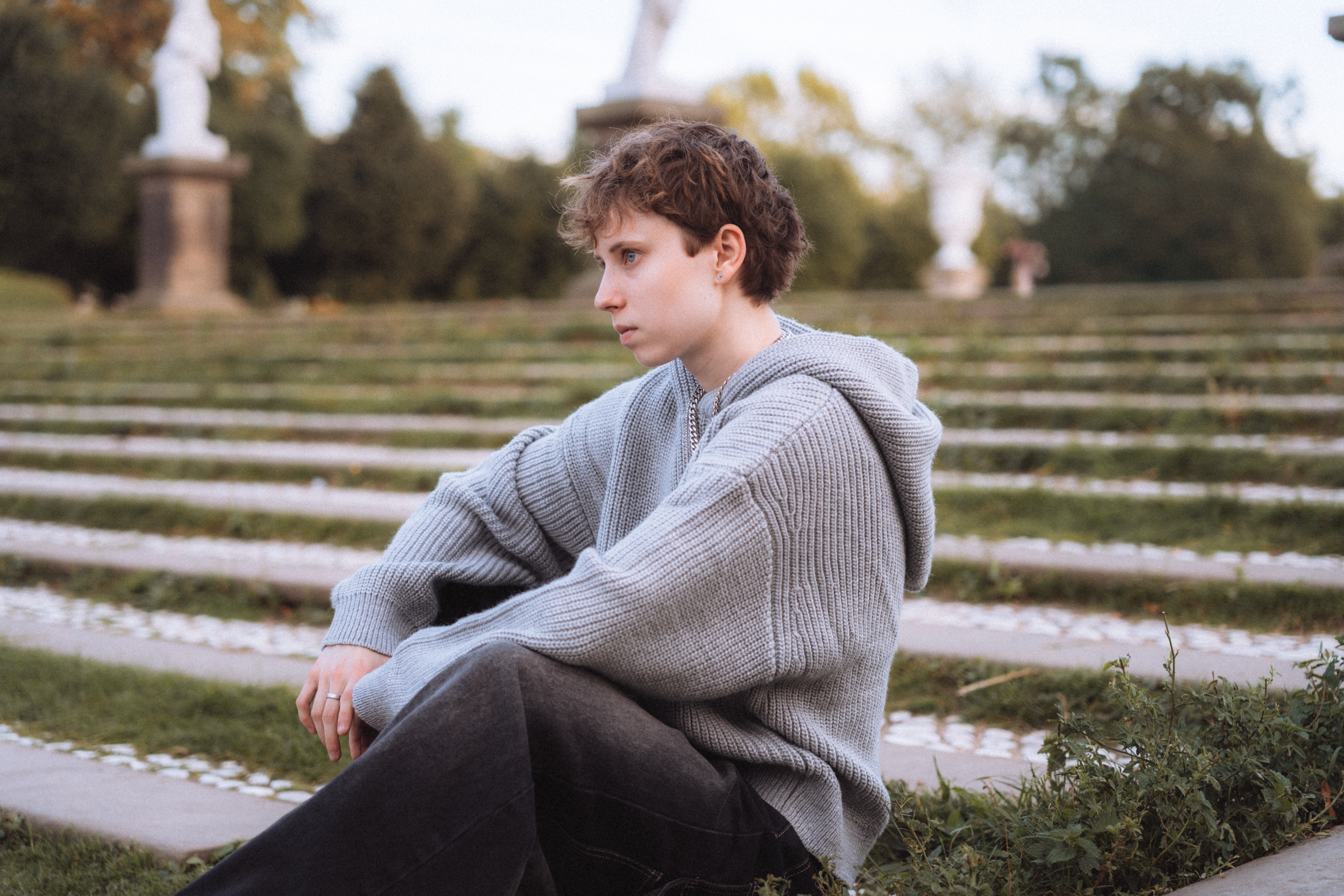 Contemplative Person Seated on Outdoor Steps · Free Stock Photo