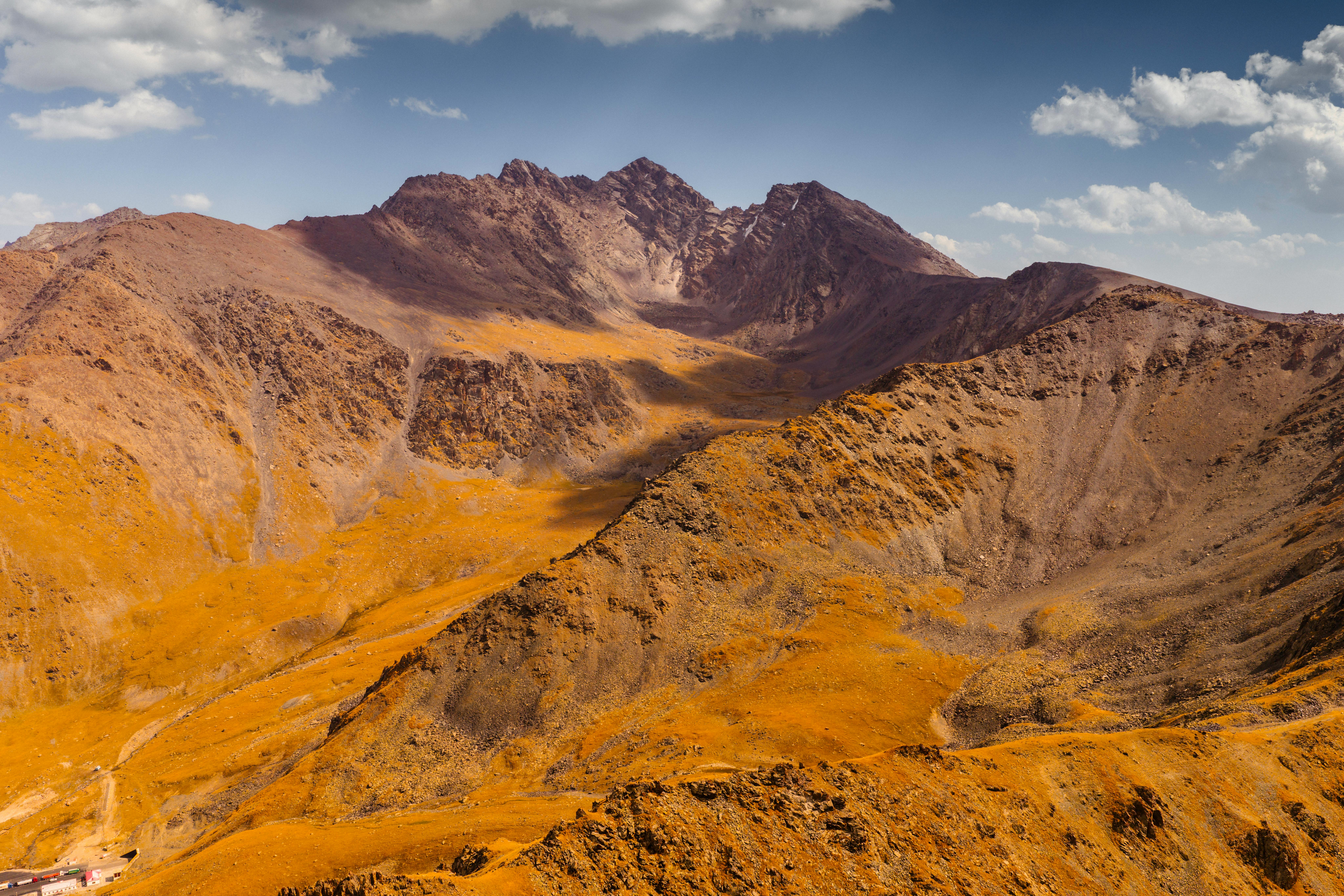 Stunning aerial view of a mountain range in Kyrgyzstan with vivid autumn colors.