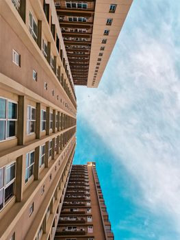 Low-angle view of modern buildings in Kolkata against a clear blue sky, showcasing urban design.