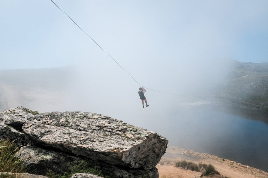 A man ziplining over foggy mountains in Merlo, Argentina, capturing adventure and serene landscapes.