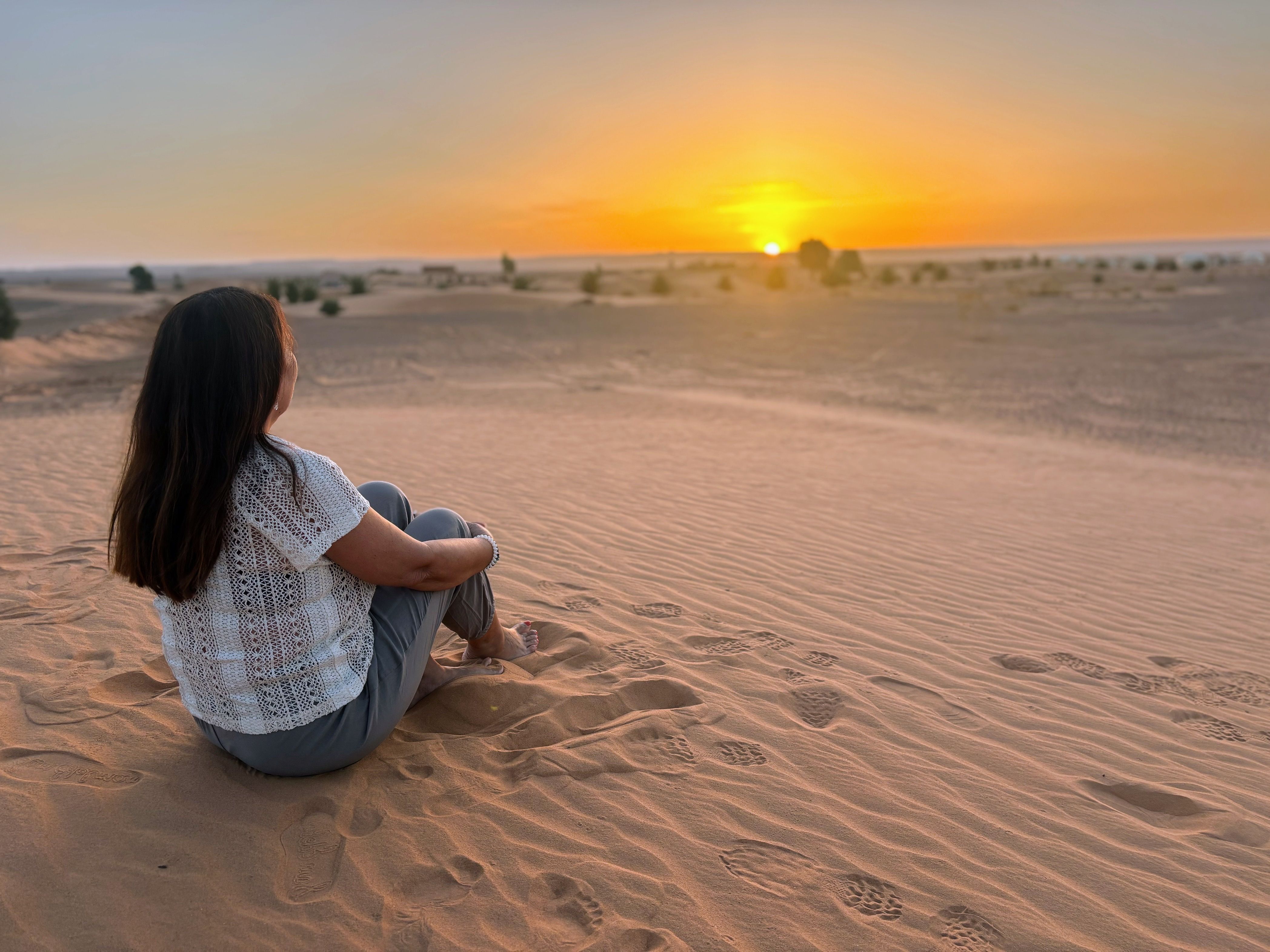 Woman Relaxing on Desert Sand Dunes at Sunset · Free Stock Photo