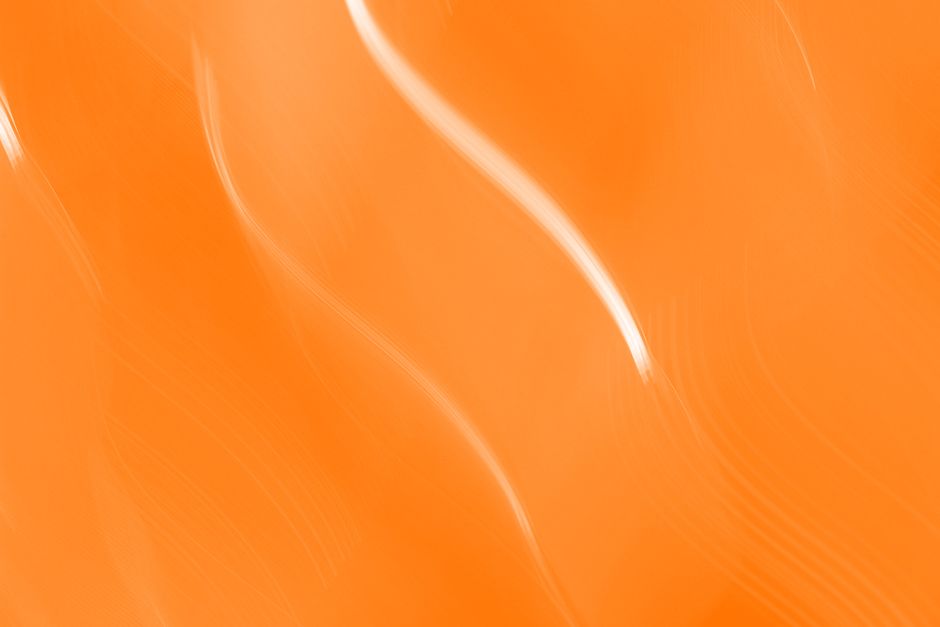A vibrant abstract image with dynamic orange waves, perfect for bold designs.