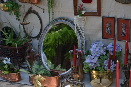 Free Artistic arrangement of vintage home decor items including mirror, candles, and flowers. Stock Photo