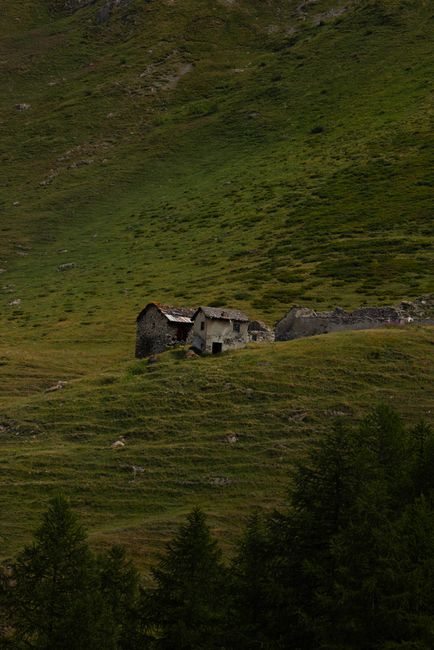 An isolated mountain cabin nestled in a lush green landscape, exuding tranquility.