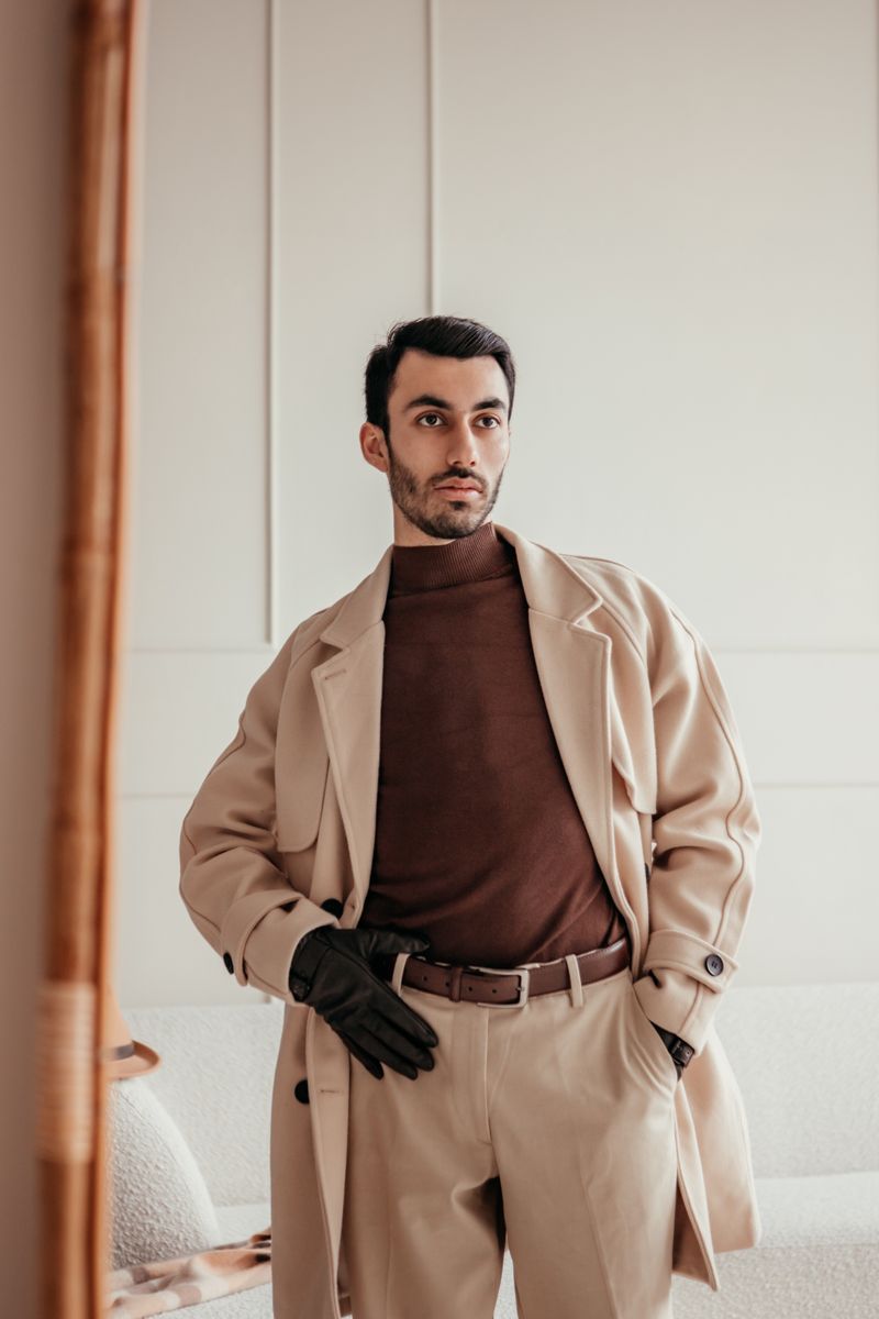Camel overcoat over a brown merino knit