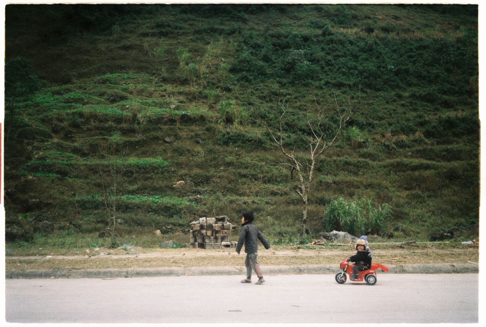 Children playing in rural Ha Giang Vietnam with mountain village scenery