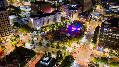 Free Aerial view of a vibrant outdoor concert in downtown Chattanooga at night. Stock Photo