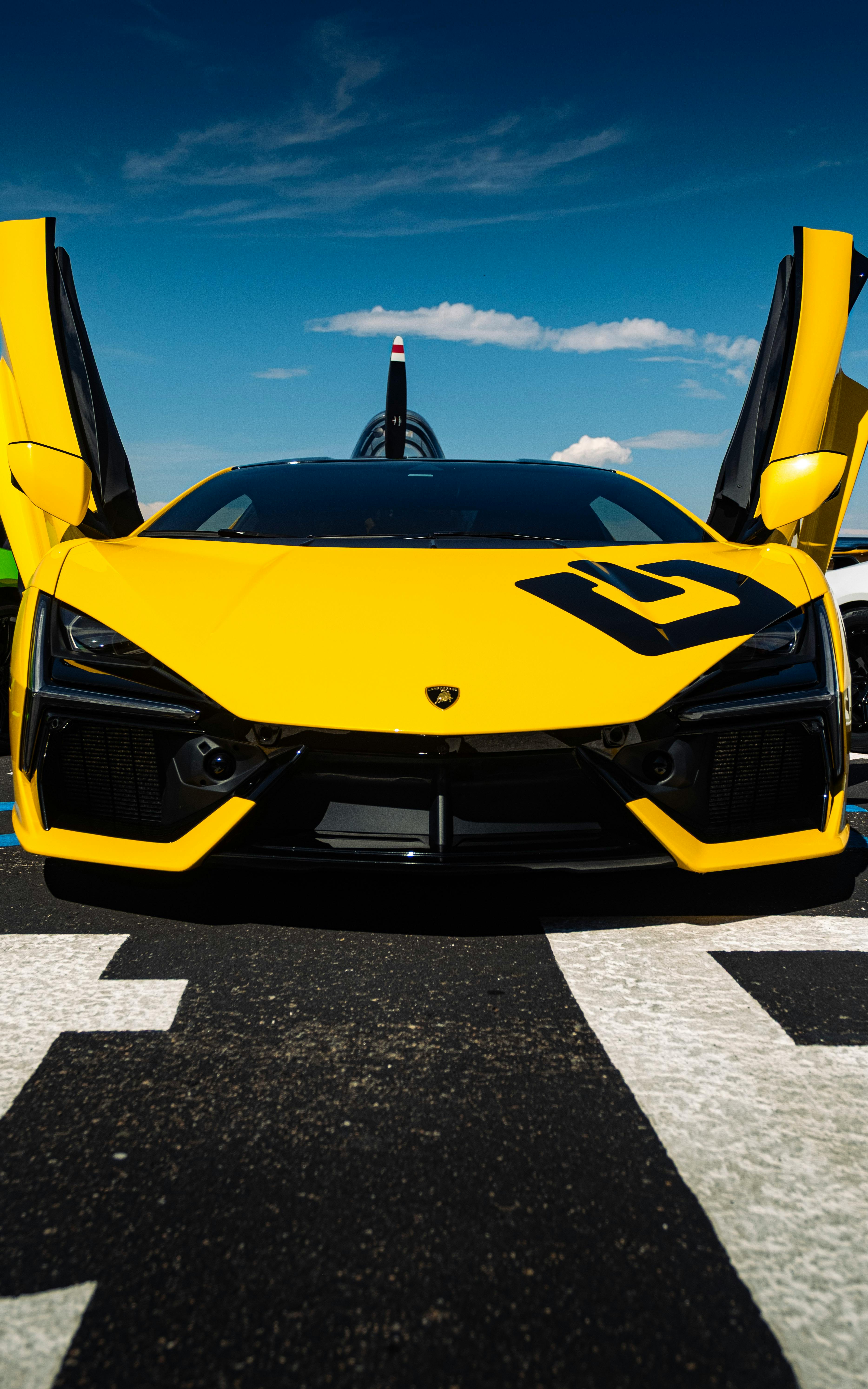 Yellow Lamborghini Revuelto Supercar in Showroom · Free Stock Photo, image size:3734x5973