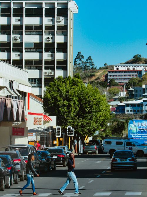 Free A vibrant street in Manzini, Eswatini, showcasing daily life with pedestrians and traffic. Stock Photo