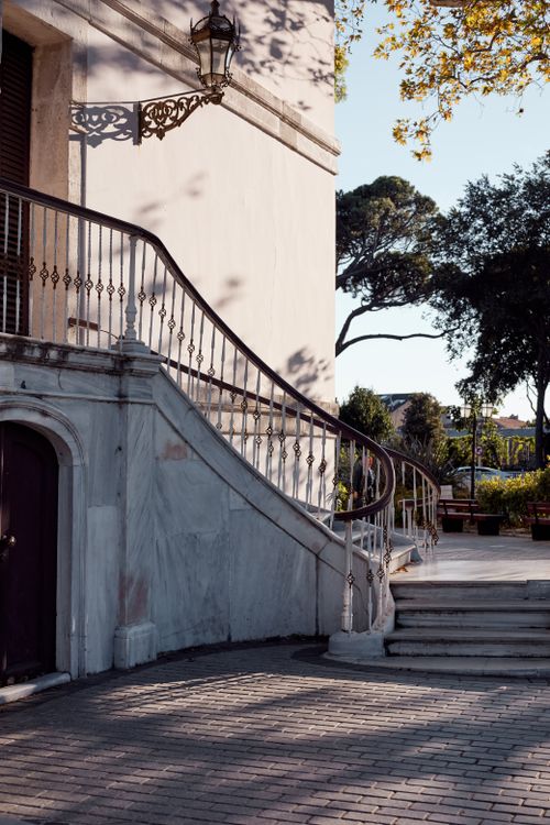 Free A beautifully curved staircase by an elegant building in a sunlit outdoor setting, ideal for travel or architecture themes. Stock Photo