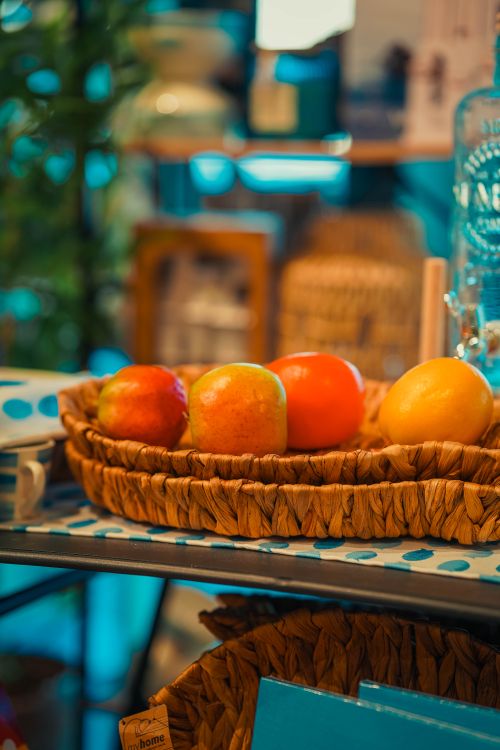 Free Colorful apples and oranges in a rustic basket on a cozy table setting indoors. Stock Photo