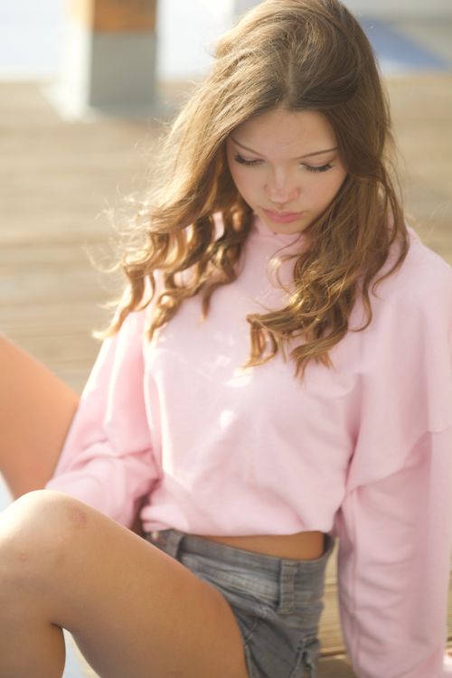 Cheerful Young Woman Posing Outdoors in Casual Attire · Free Stock Photo