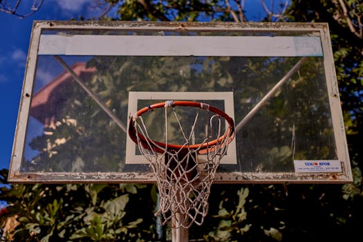 Old basketball hoop under clear sky in İstanbul park, ideal for sports and recreation themes.