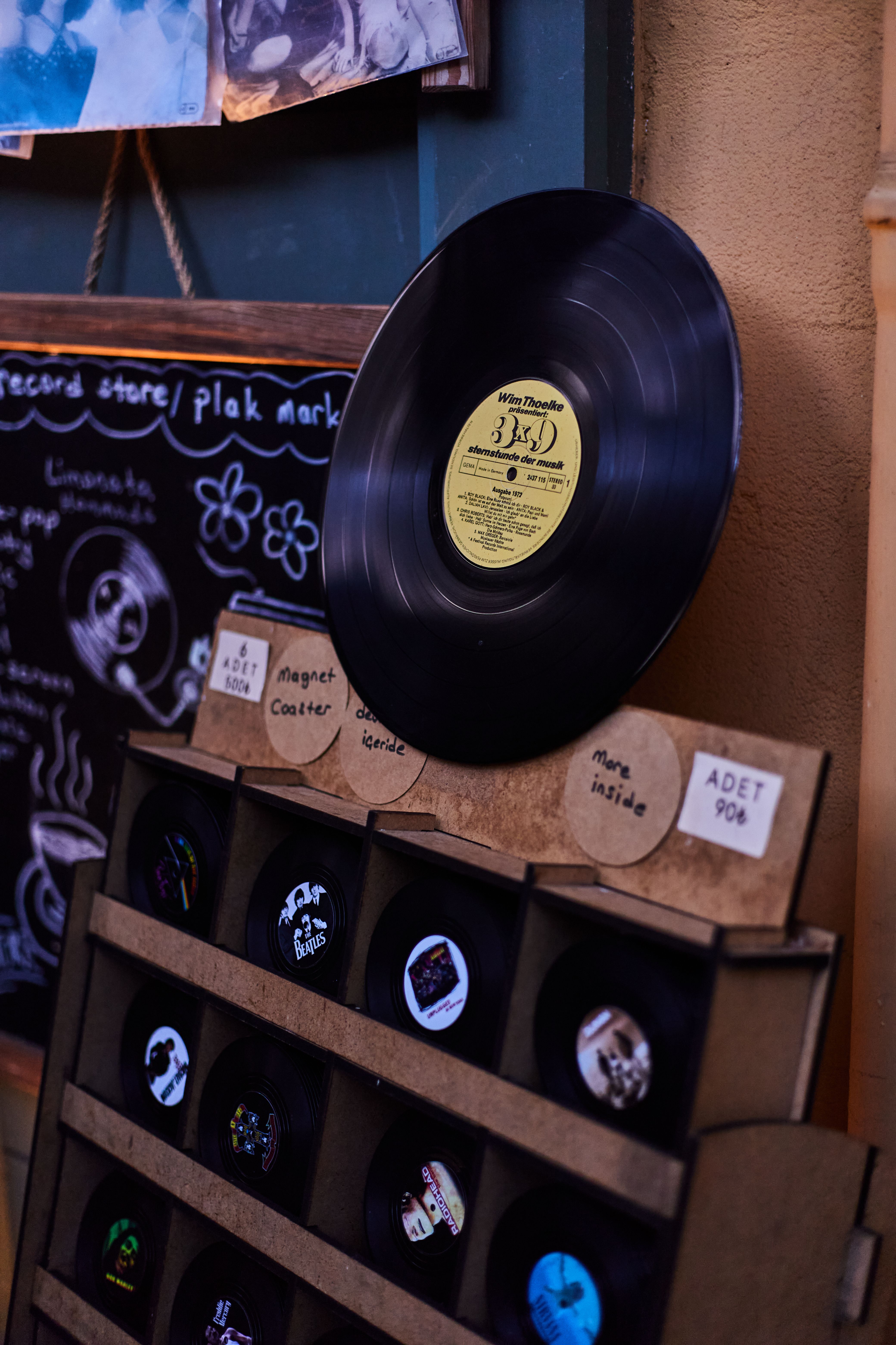 Retro vinyl collection display in an İstanbul shop with colorful chalkboard backdrop.