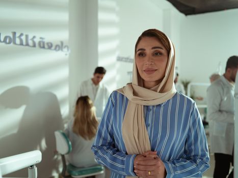 Confident Middle Eastern woman in modern office environment, showcasing leadership.