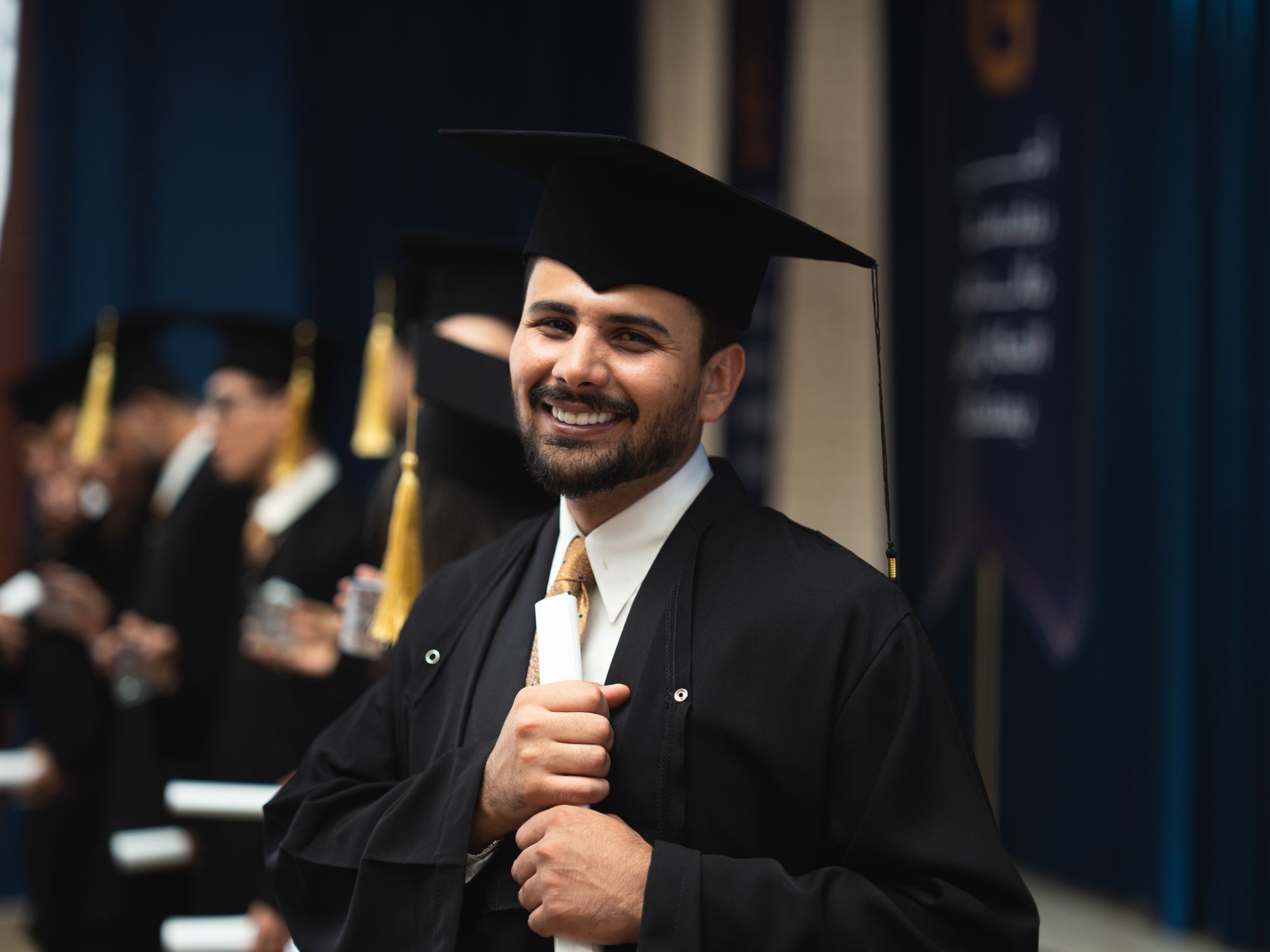 Smiling Graduate Smiling Graduate Holding Diploma at Ceremony · Free Stock Photo