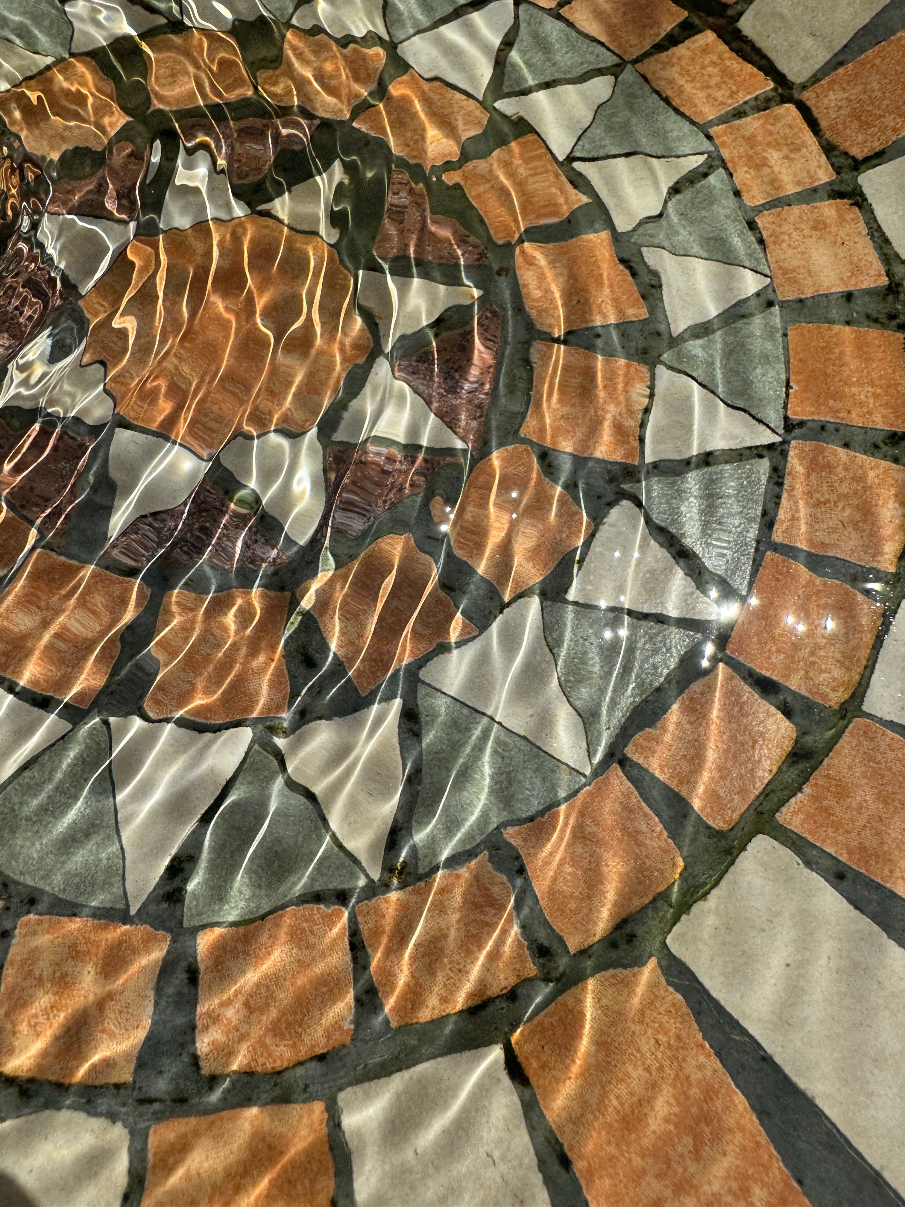 Artistic mosaic pattern with water ripples creating a dynamic and reflective surface, ideal for creative projects.