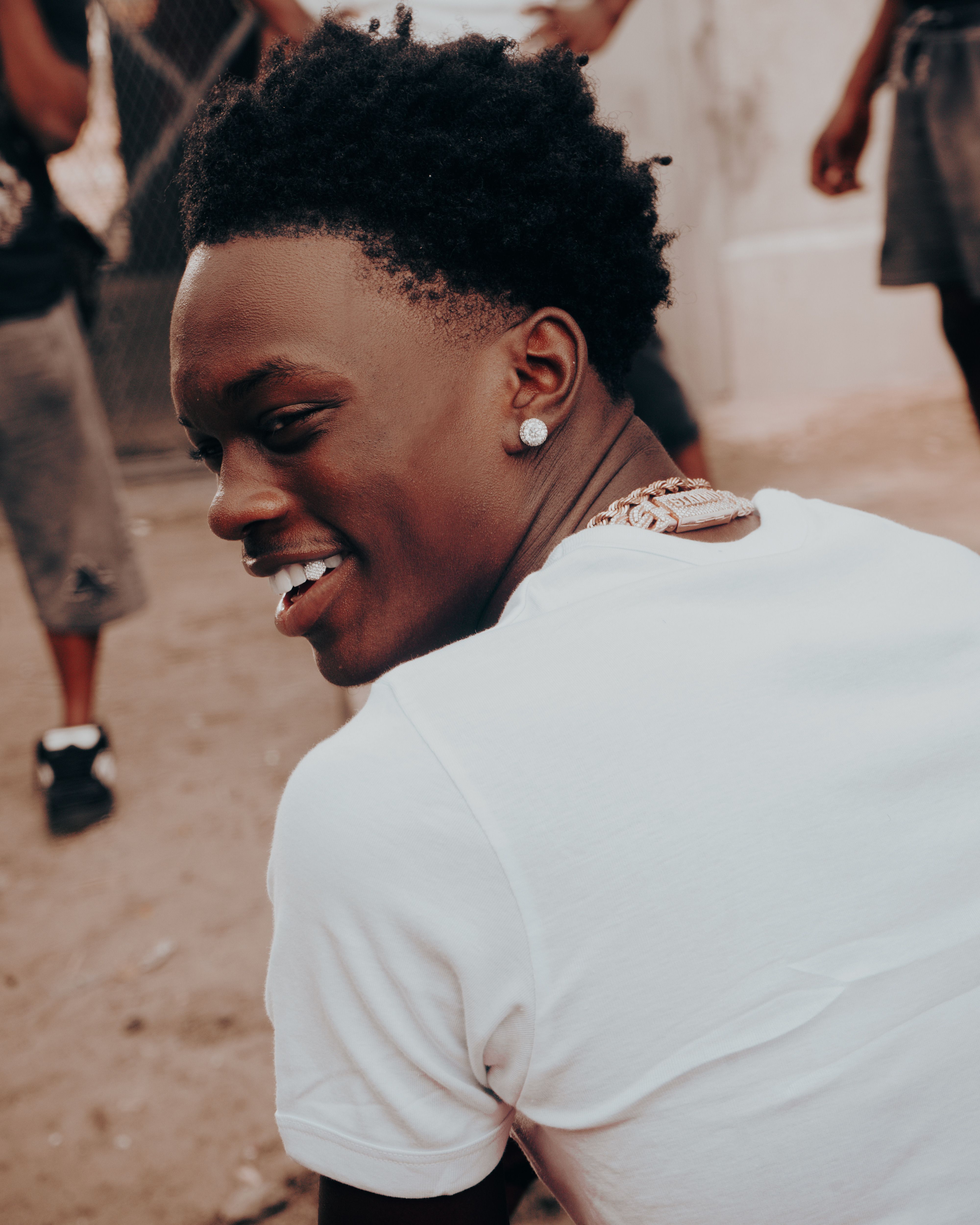 Young Man Smiling Outdoors in Urban Setting · Free Stock Photo