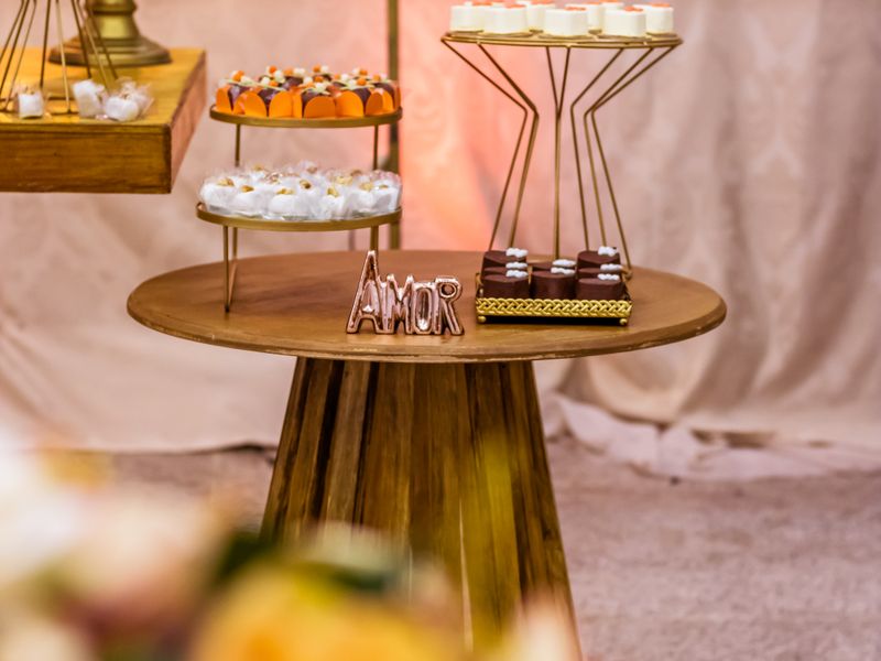 Dessert table with decorative cakes and Amor sign