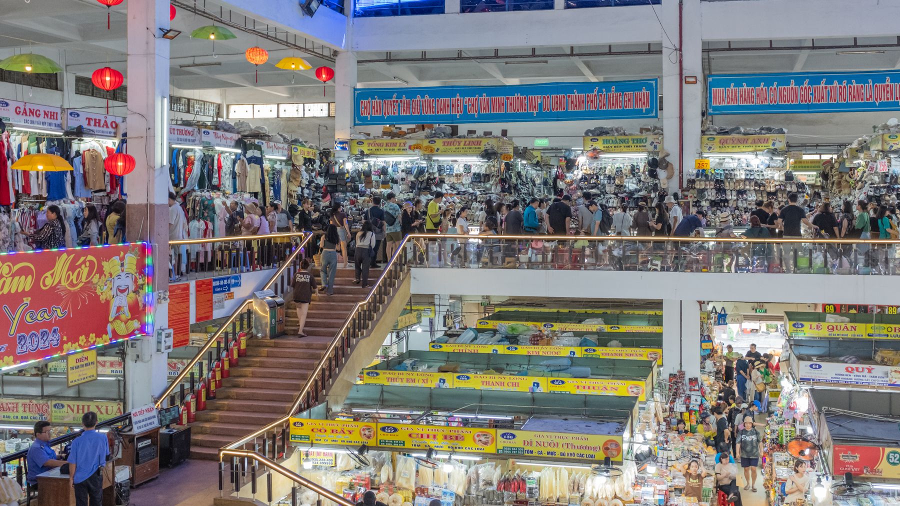 Explore the vibrant Han Market in Da Nang, Vietnam, bustling with shoppers and local goods.