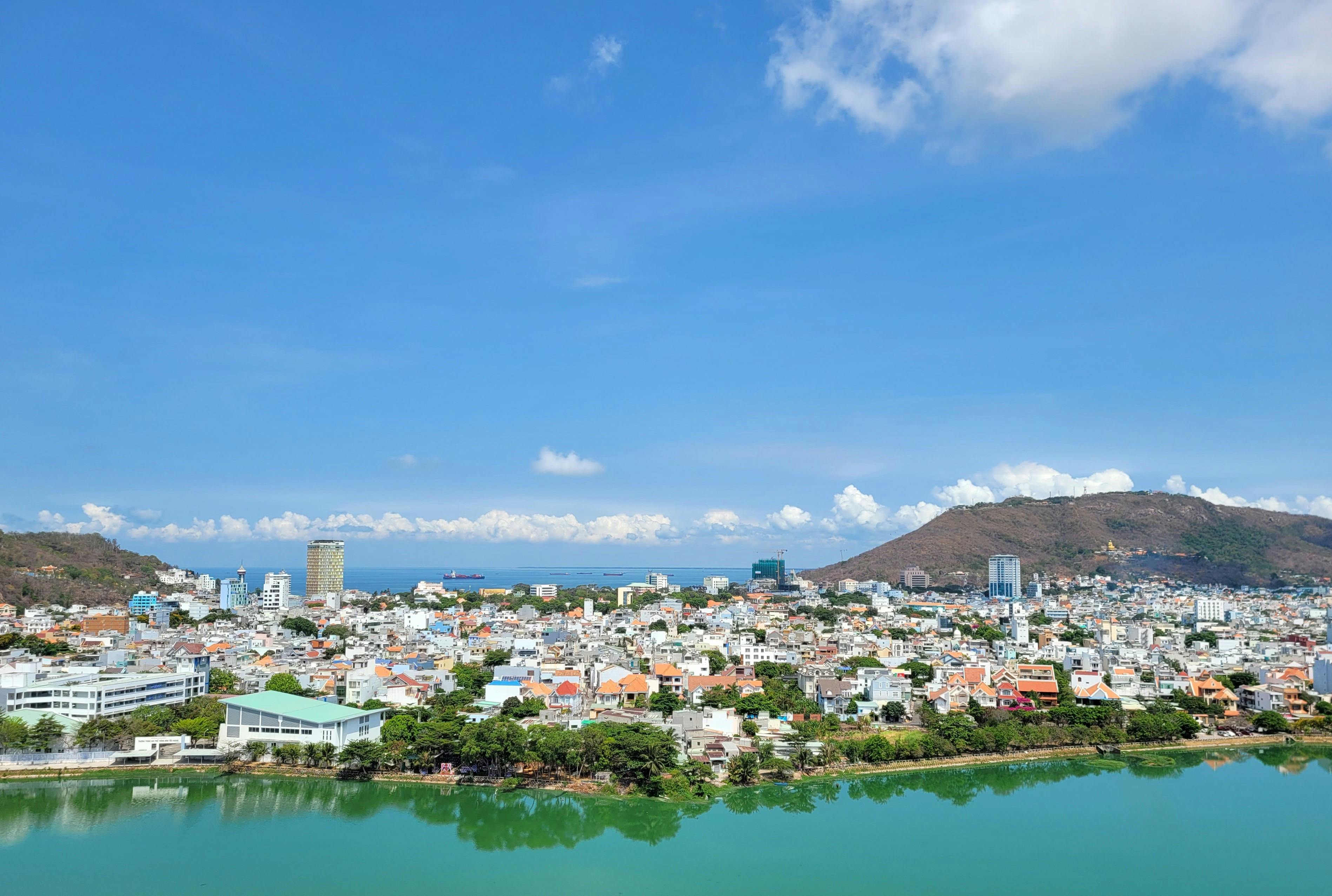 A stunning aerial view of Vung Tau's coastal cityscape under a clear blue sky.