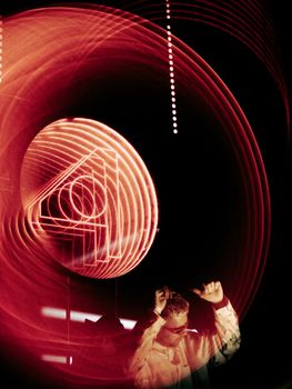 Dynamic light trails with a man dancing below, creating a vibrant visual impact.