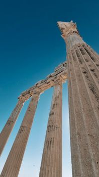 Majestic ancient columns of the Temple of Apollo in Side, Turkey against a clear blue sky.