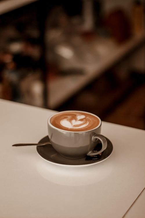 Free Warm and cozy coffee shop ambiance in Kermanshah with elegant latte art. Stock Photo