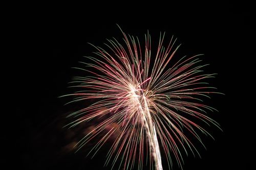 Free Colorful fireworks burst against a dark night sky, creating a vivid and celebratory scene. Stock Photo