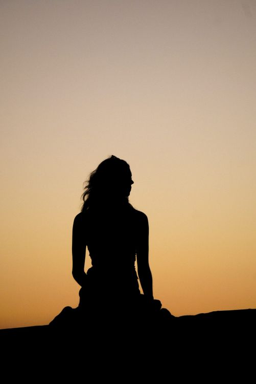 Silhouette of a Woman at Sunset · Free Stock Photo
