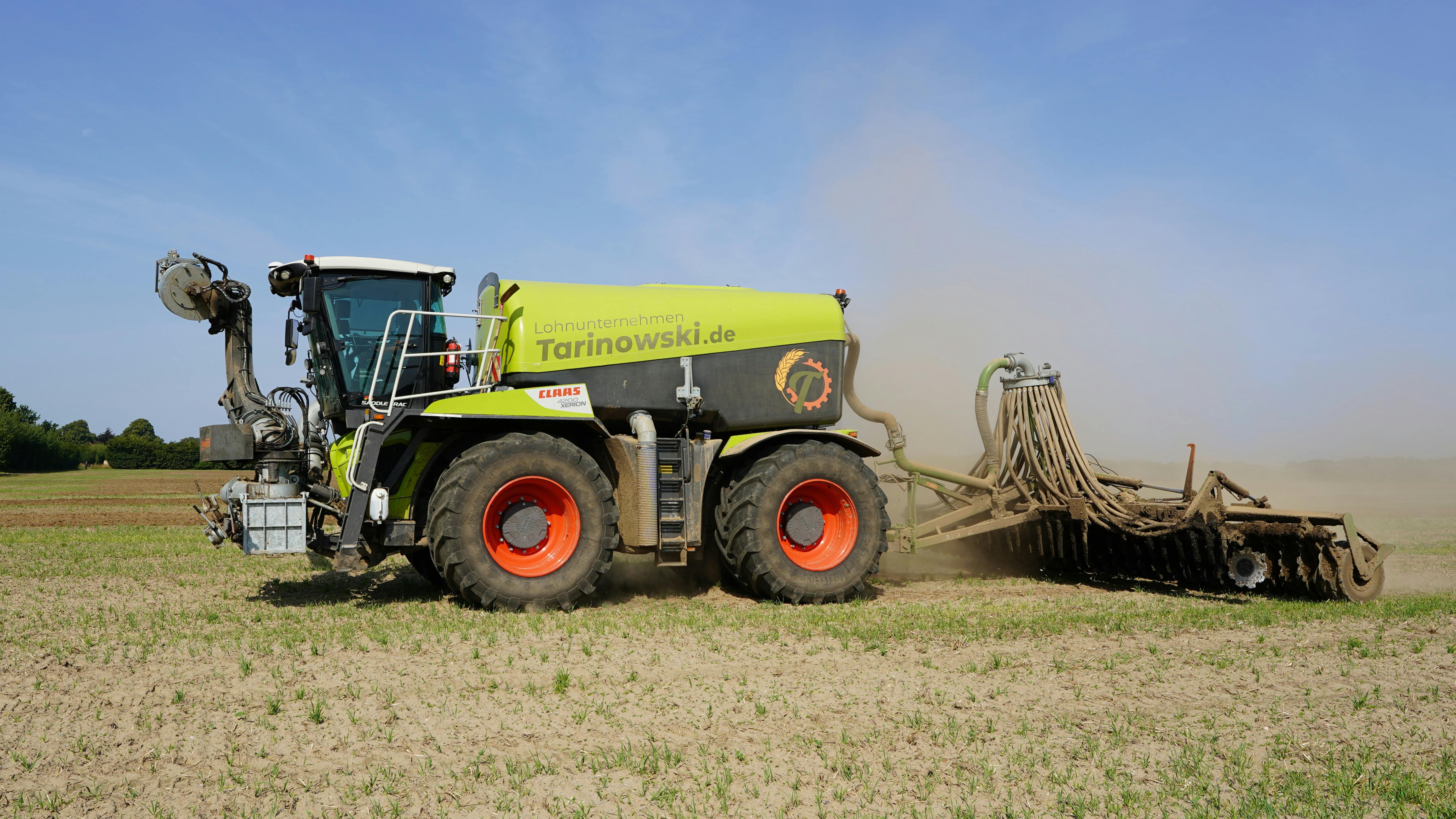 A powerful farming machine plowing fields in Schleswig-Holstein, Germany.
