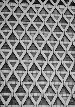 Close-up of a geometric facade of a high-rise building in Jakarta, Indonesia, showcasing modern architecture with diamond patterns.