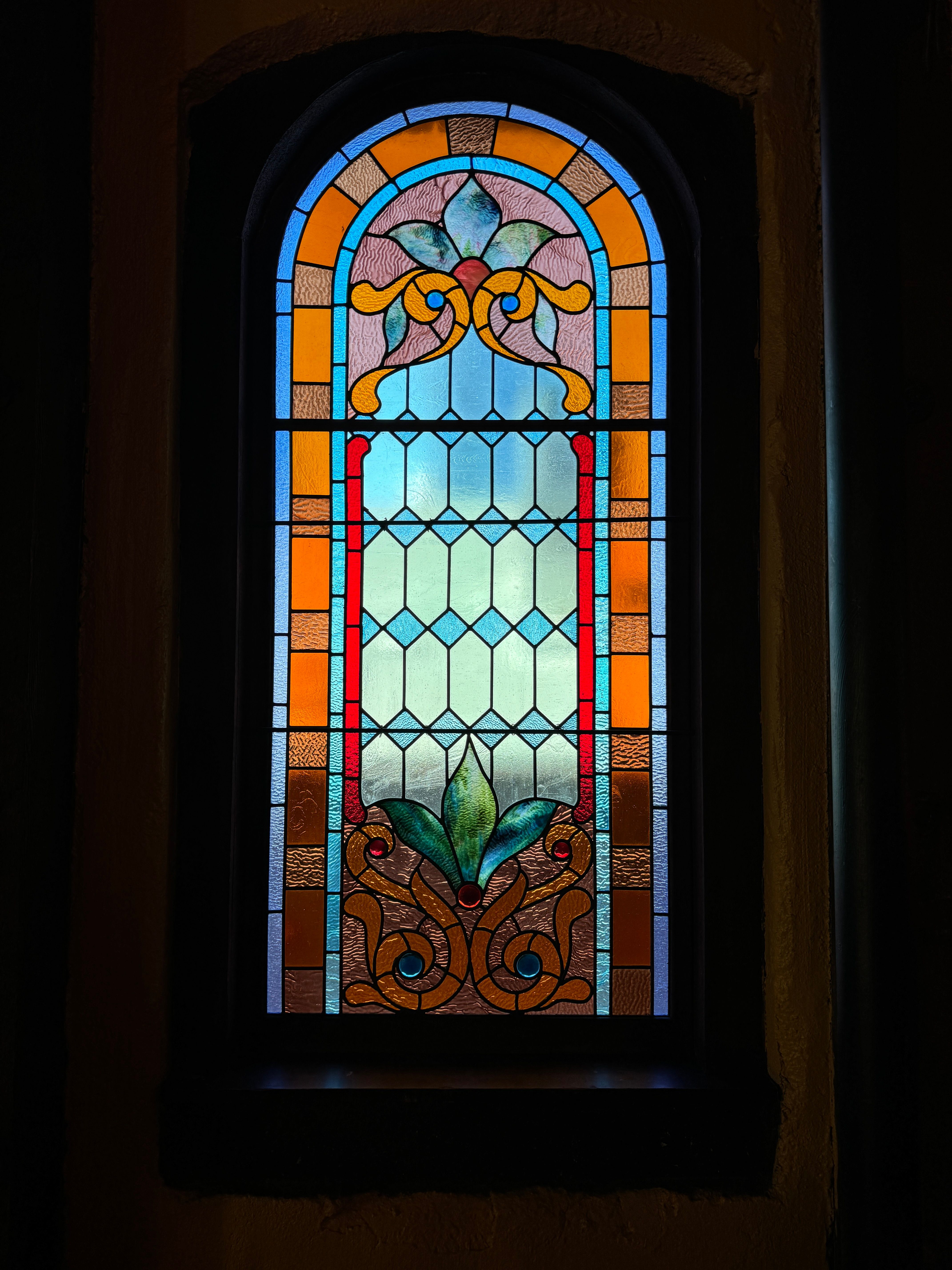 Vintage stained glass window showcasing intricate craftsmanship and vibrant colors.