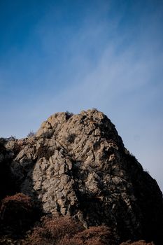 A rugged rocky cliff under the clear blue sky in Ankara, Türkiye, showcasing natural beauty and geological formations.