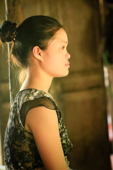 Profile portrait of a woman in traditional attire, exuding serenity indoors.
