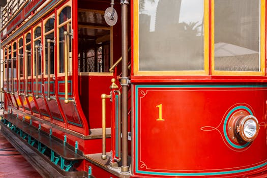 Close-up of a vibrant red vintage tram in Dubai, showcasing retro design elements.