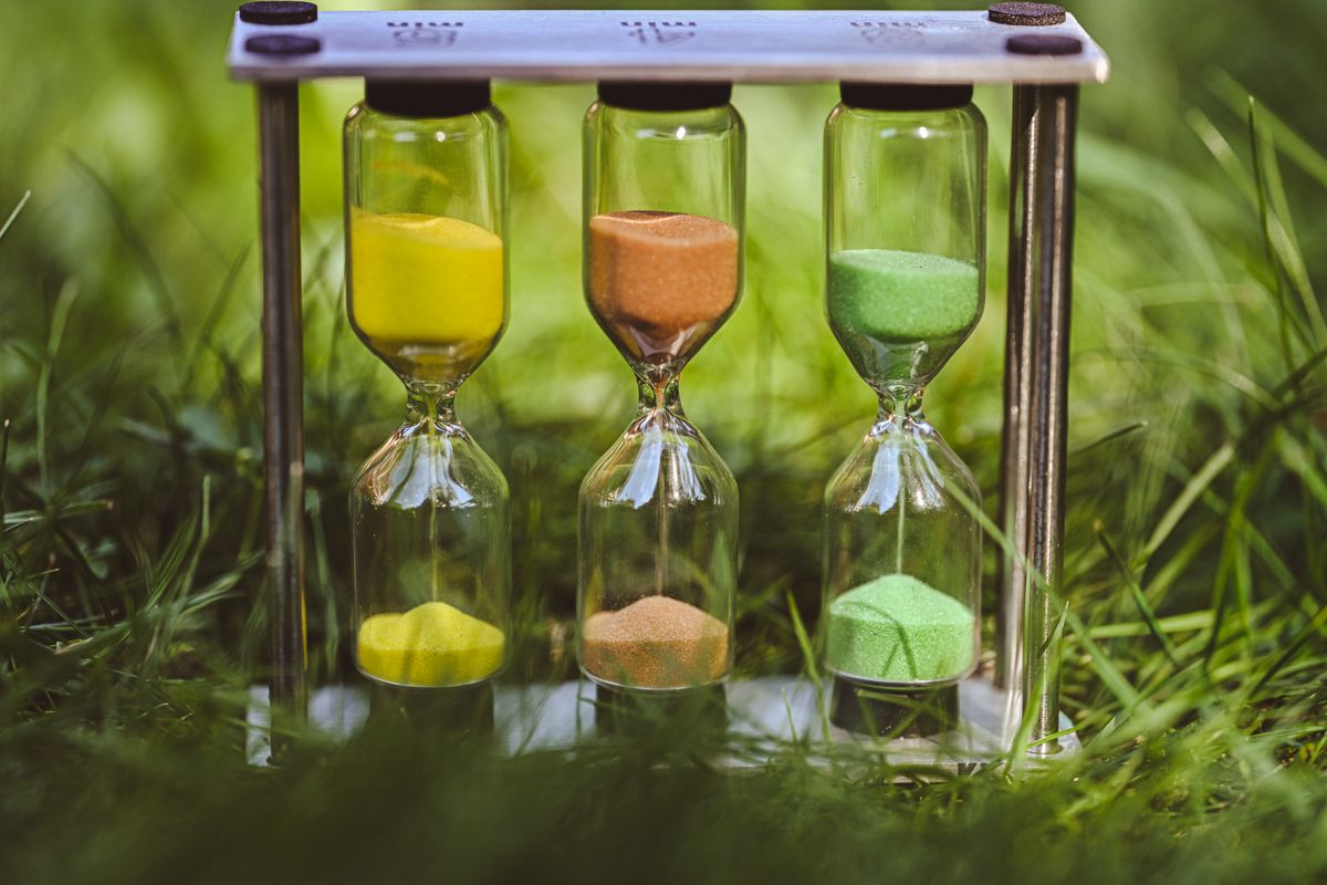 Colorful hourglass with sand running out, representing now or never urgency marketing for AI side hustles