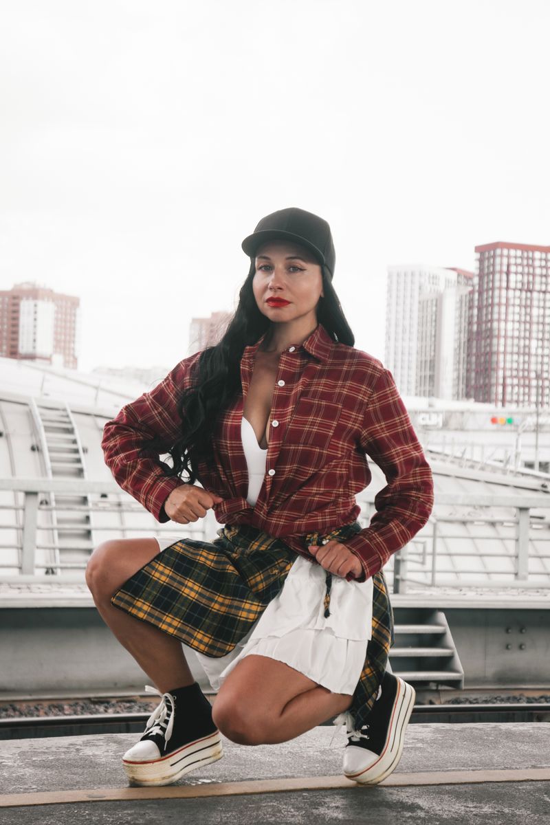 Woman in plaid flannel shirt and sneakers