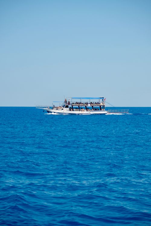 Free Enjoy a tranquil boat ride on the vibrant blue waters of Antalya, Türkiye, under a clear sky. Stock Photo