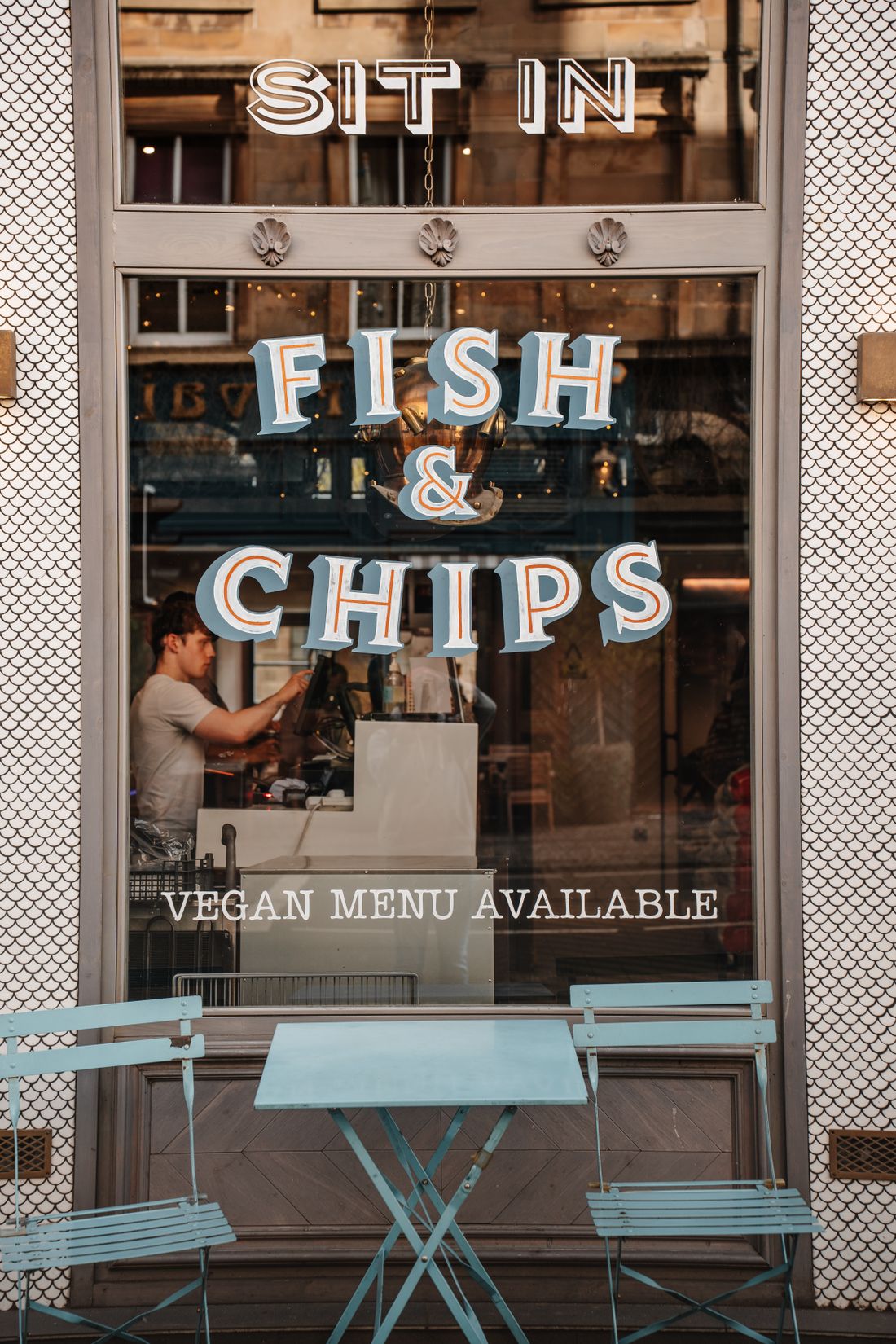 Tables set out inside a fish and chip restaurant