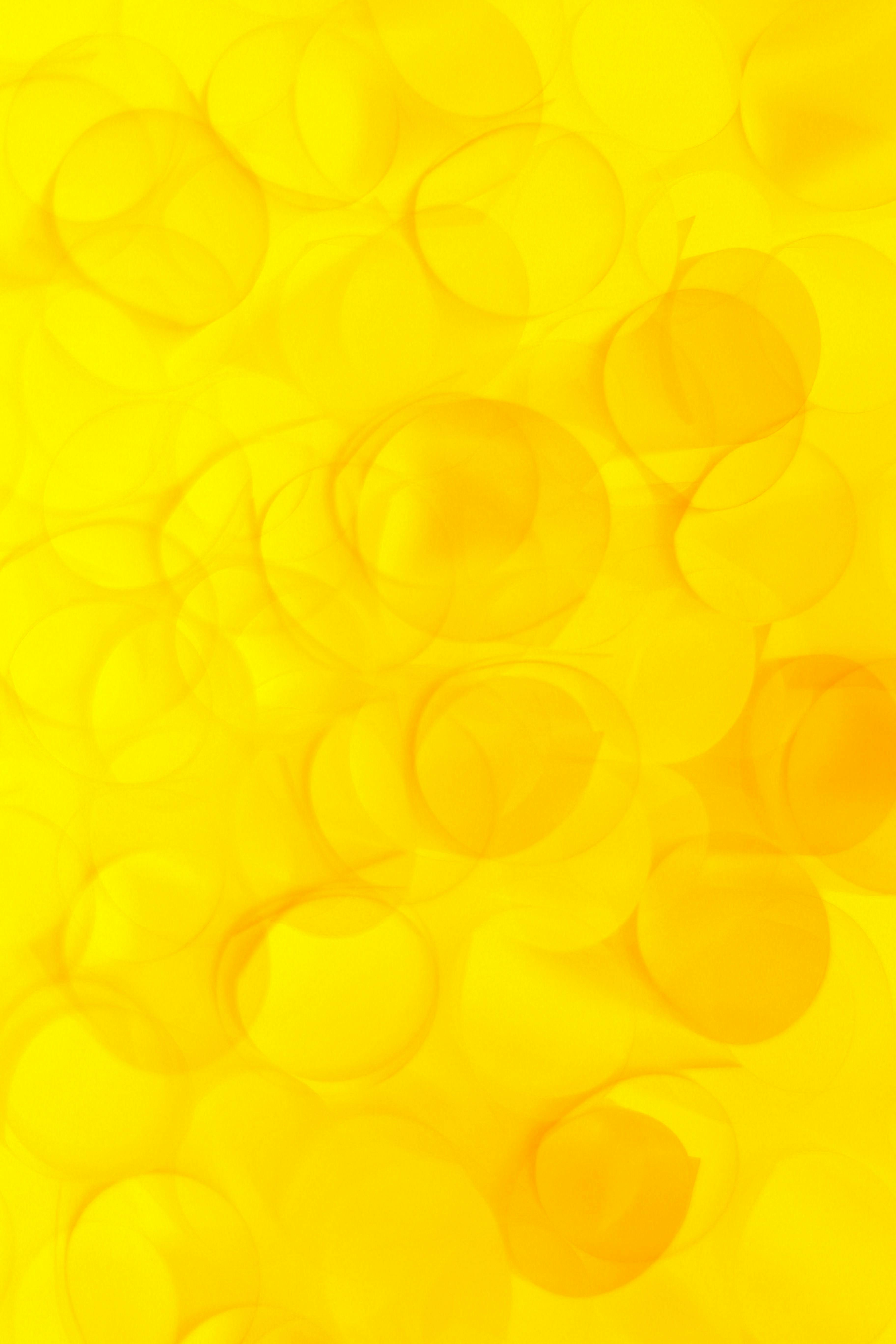 grátis Padrão abstrato brilhante e vibrante de círculos amarelos sobrepostos, perfeito para designs modernos. Foto profissional