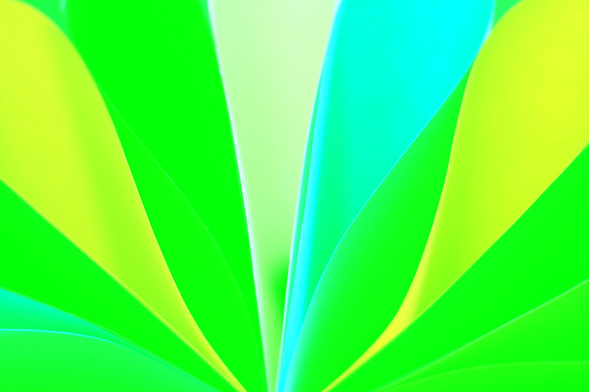 Close-up of vibrant folded paper in abstract pattern with green and blue hues.