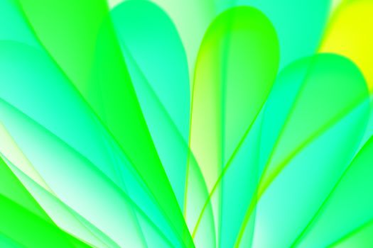 Abstract image featuring a vibrant pattern of green and yellow overlapping leaf shapes.