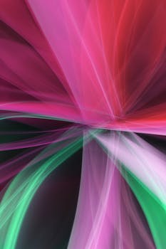 Vibrant abstract light streaks in pink, red, and green create a dynamic visual display.