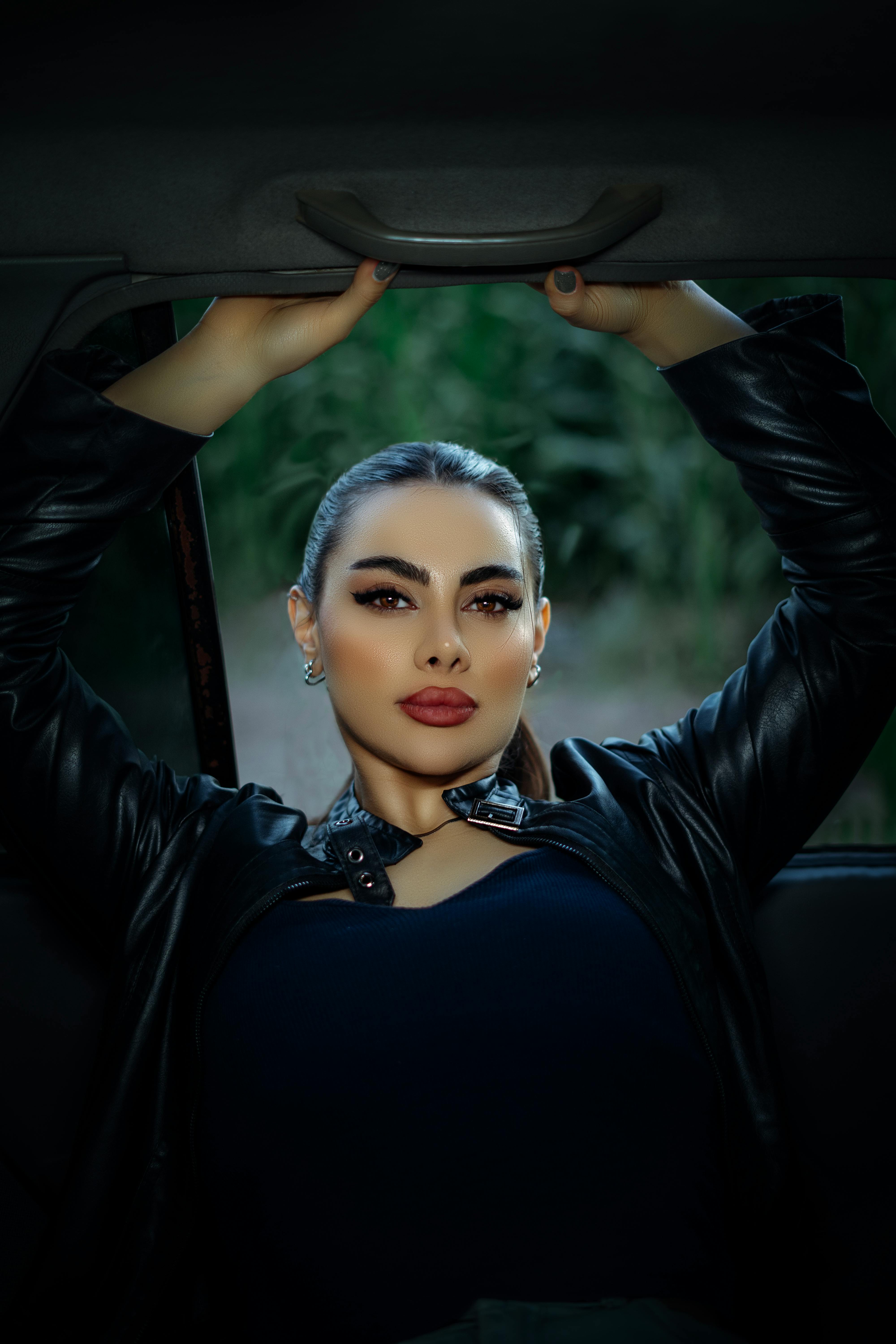 Striking portrait of a woman posing confidently in a car, Qazvin, Iran.