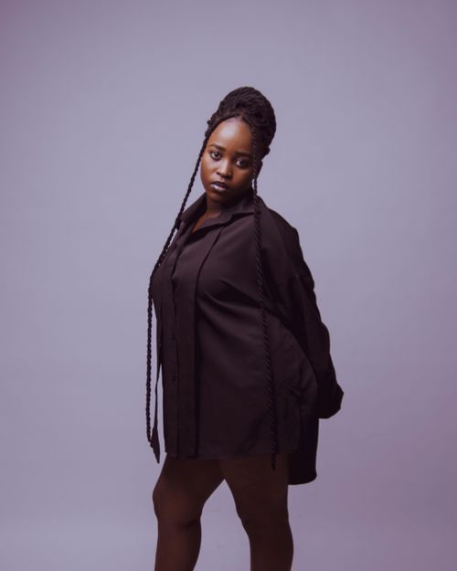 Free Studio portrait of a woman in black fashion with braided hair. Minimalist and modern style. Stock Photo